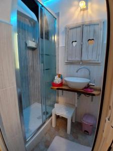 a bathroom with a glass shower and a sink at Casetta delle Fate , sport e natura in Noli