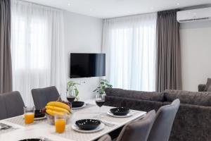 a dining room with a table and a couch at Villa Amantia in Kouvaláta