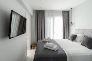 a bedroom with a large bed with towels on it at Villa Amantia in Kouvaláta +49 photos