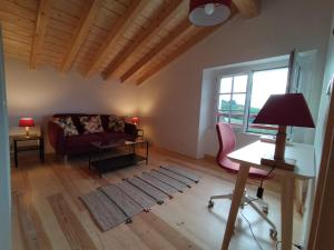 a living room with a red couch and a table at Maison basque de charme avec piscine in Souraïde