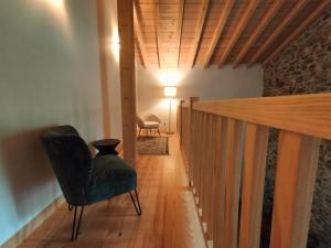 a hallway with a chair and a table and a lamp at Maison basque de charme avec piscine in Souraïde