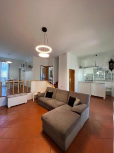 a living room with a couch and a kitchen at Denise B&B 