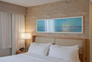 a bedroom with a bed with white pillows at Holiday Inn Washington-Central/White House by IHG in Washington, D.C.