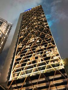 a tall building with a geometric design on it at Scarletz Suites KLCC by Classic in Gua Sai