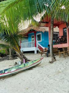 a house on the beach with a boat on the sand at Lamai Beachfront Bungalow Koh-Rooms in Koh Samui 