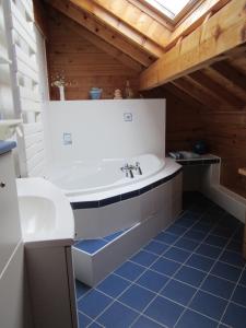 a large bathroom with a tub and a sink at Les chalets de Jade in Viremont