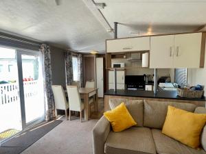 a living room and kitchen with a couch and a table at South Bay Hideaway, Brixham in Brixham