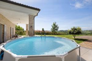 a large plunge pool in the backyard of a house at Casa di Ercolino in Moasca