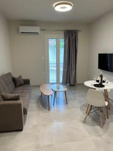 a living room with a couch and a table at Victoria's & Anna's Apartments in Sami