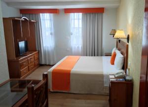 Ein Bett oder Betten in einem Zimmer der Unterkunft Hotel Báez Carrizal