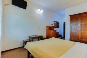 een slaapkamer met een bed en een houten kast bij Hanul Ursilor in Tîrgu Neamţ