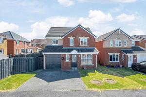 a red brick house with a garage at Super Prime Luxury 4 Bedroom Detached Home By Tba in Fife
