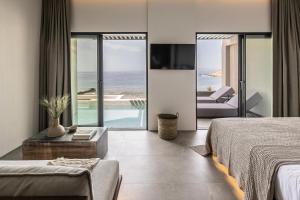a hotel room with a view of the ocean at Orion Tinos Suites in Vrachonisída Chántra +57 photos