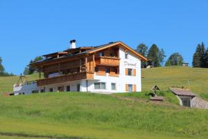 a house on top of a hill at Apartments DAMONT in Santa Cristina Gherdëina