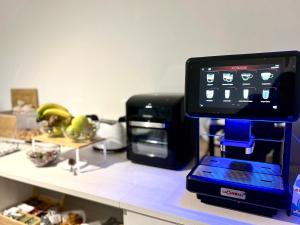 a coffee machine sitting on a counter next to a microwave at B&b FONTANA GIULIA in Sersale
