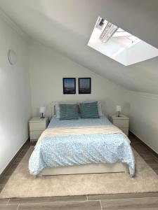 a bedroom with a bed and two night stands at Ponto de vista in Angra do Heroísmo