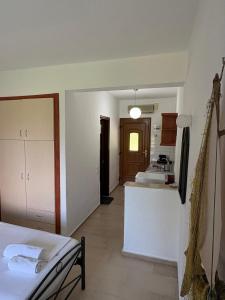 a room with a kitchen and a counter in it at Studios Galanis in Afitos
