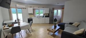 a living room with a couch and a table at Annie's Apartment in Ialyssos +12 photos
