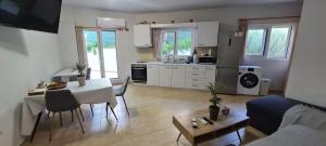 a kitchen and living room with a table and a couch at Annie's Apartment in Ialyssos
