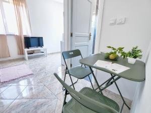 a dining room with a green table and chairs at Villa Paris in Nečujam