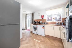 a kitchen with a washer and dryer at Super Prime Luxury 4 Bedroom Detached Home By Tba in Fife