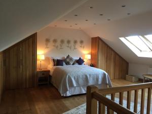 a bedroom with a bed and a skylight at The Apple Shed in Farmborough