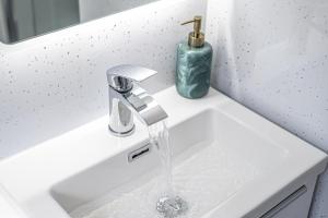 a bathroom sink with water running from a faucet at Super Prime Luxury 4 Bedroom Detached Home By Tba in Fife +26 photos