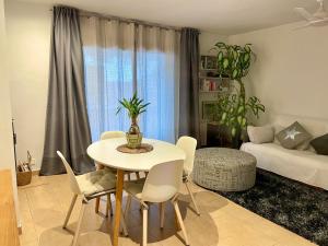 a living room with a table and chairs and a couch at Casa en Sant Antoni de Calonge in Calonge +10 photos