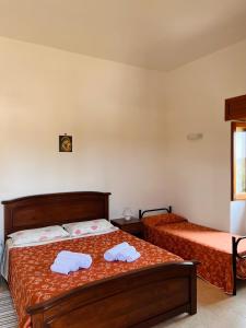 a bedroom with two beds with towels on them at B&B Casale Spisari in Galatone