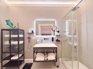 a bathroom with a sink and a shower at Luxury Suite - Free WifI - Smart Tv - centro Storico in Mesagne +19 photos