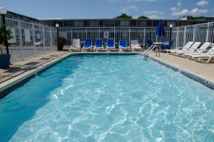 a swimming pool with chairs at SeaLoft Oceanfront Hotel in Ocean City