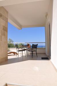 a view from the balcony of a house with a table and chairs at Apartments Gabriela in Drasnice +35 photos