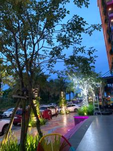 a street with cars parked in a parking lot with lights at Flamingo Hải Tiến in Gò Ba Quần