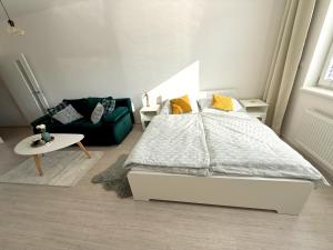 a bedroom with a bed and a couch at PonaSpace Apartment in Husovice