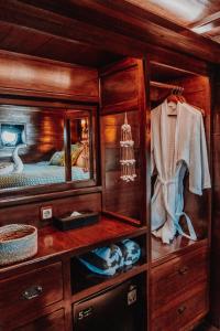 a wooden room with a bed and a mirror at Behike Luxury Phinisi in Labuan Bajo