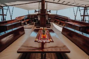 a table in the middle of a boat at Behike Luxury Phinisi in Labuan Bajo