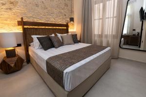 a bedroom with a large bed and a mirror at Madonna del Mare City in Chania