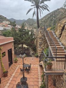 a staircase leading up to a building with a palm tree at Tamahuche Hotel Rural in Vallehermoso