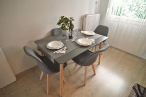 mesa de comedor con sillas, mesa negra y sillón en Azure, en Kastoria