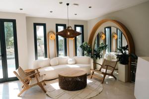 a living room with a white couch and a table at Casa Olea Apart Hotel in Çeşme