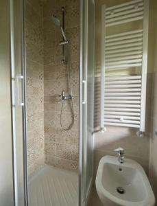 a bathroom with a shower and a toilet and a sink at Il Nido Del Ricetto in Roppolo +10 photos