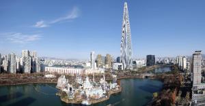 eine Luftaufnahme einer Stadt mit einem hohen Turm in der Unterkunft 잠실역 근처 가족숙소 더하리하우스 in Seoul