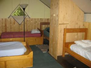 a bedroom with two beds and a lamp in it at Sven's Basecamp Hostel in Fairbanks