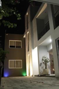 a house with lights on the side of it at night at House Lilies in Oaxaca City +5 photos