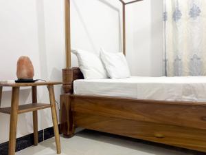 a bedroom with a bed with white sheets and a chair at Kwale Residence in Zanzibar City +18 photos