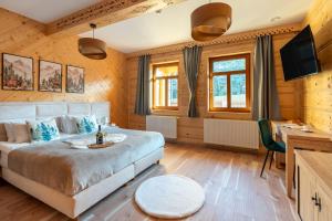 a bedroom with a large bed and a desk at Gawrówka in Kościelisko