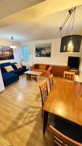 a living room with a table and a couch at Apartmán Špindl 101čka Dalibor II in Špindlerův Mlýn