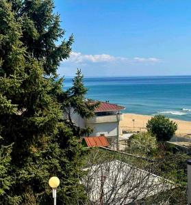 a building with a view of a beach and the ocean at Kabakum Sea Apartment in Varna City