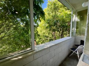a window on a porch with a view of trees at Studio Thermi 1 in Varna City +49 photos