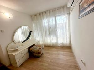 a bathroom with a sink and a mirror at Kabakum Sea Apartment in Varna City